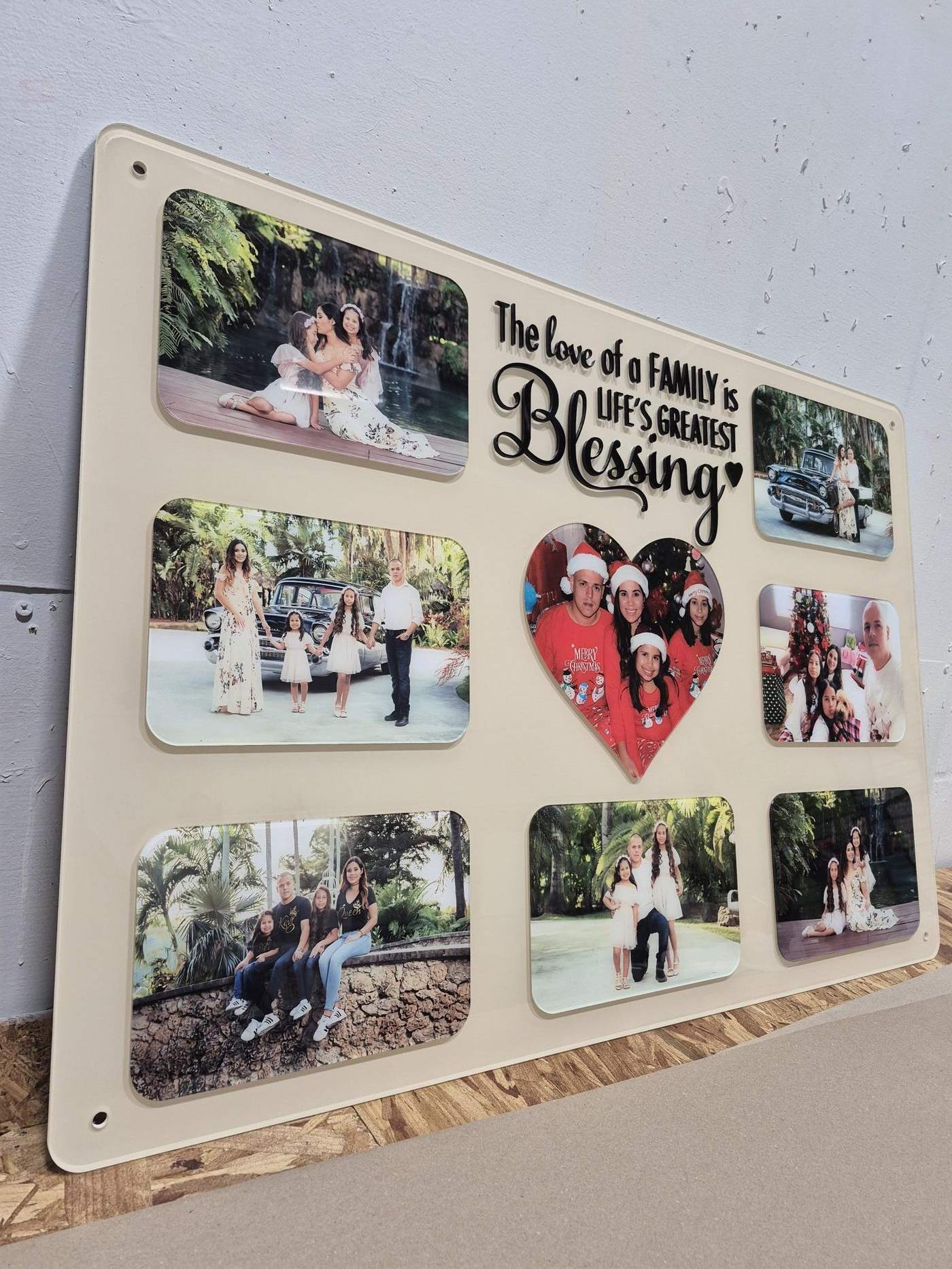 An angled view of a printed memorial photo collage board showing the raised script lettering standing off the panel, made in our Tampa shop.