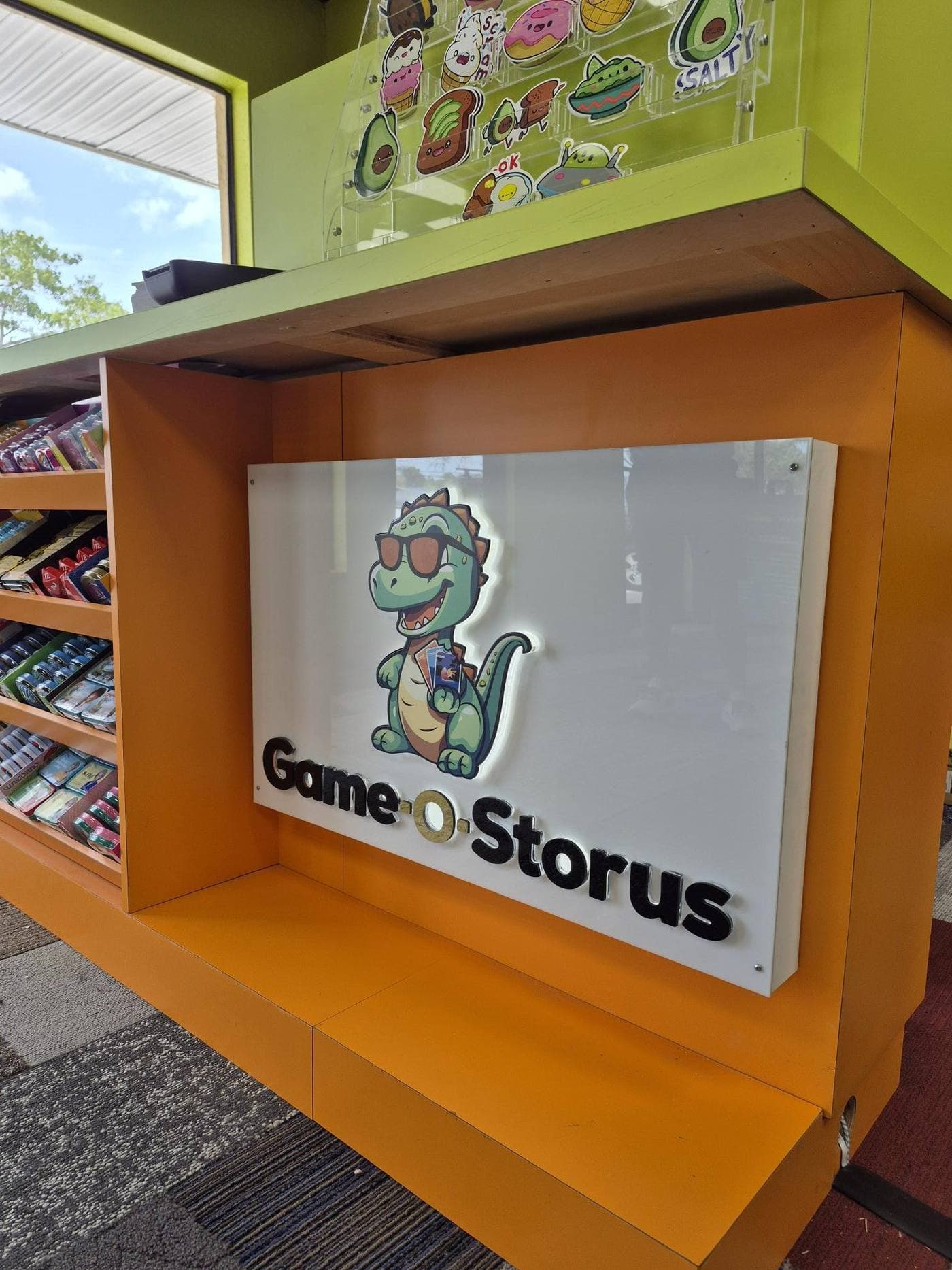 Backlit retail counter logo sign mounted on an orange service counter